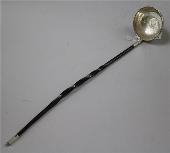 An 18th century white metal toddy ladle, with inset coin bowl and baleen handle, 36.6cm.